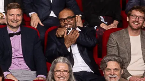 AMPAS Clarence Maclin in the 97th Oscars nominees dinner class photo