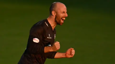 Jack Leach, wearing Somerset's black T20 shirt, celebrates taking a wicket against Worcestershire