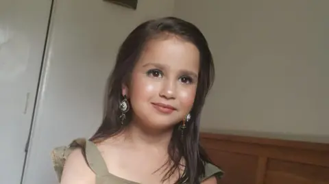 PA A young girl. She is wearing makeup. 