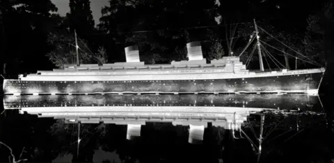 Leamington Spa Art Gallery and Museum A black and white photo of an ocean liner lit up in the gardens