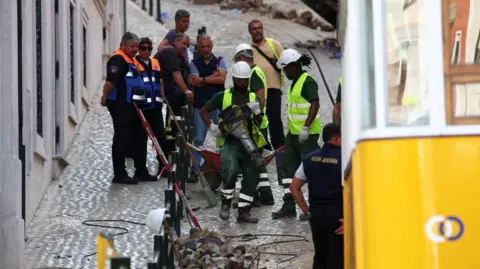 Reuters Rescue workers assessing funicular after crash in Lisbon
