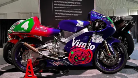 The 1999 Lightweight bike, which is blue and red with Vimto sponsorship logo on the side.