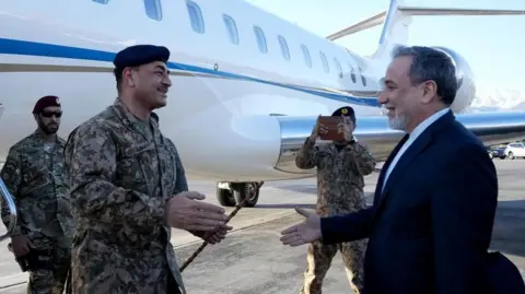 EPA Pakistan's army chief arrives off a plane in Tehran. 