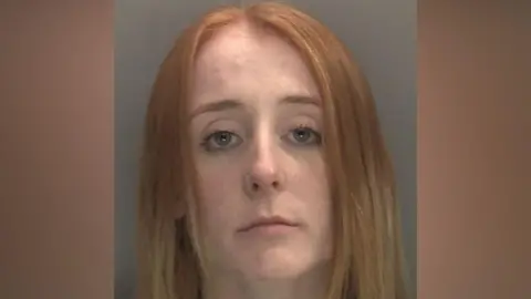 West Midlands Police A custody image of Kimberley Cookson, a blonde woman with blue eyes against a grey background