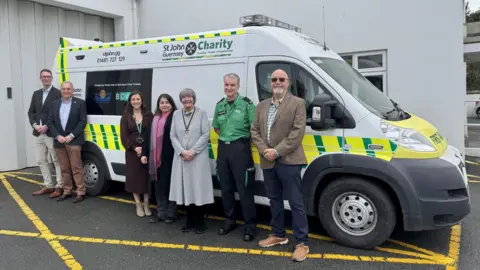 St John Guernsey Representatives of St John Guernsey, BOW Trustees and the Rotary Club of Guernsey stand in front of a new ambulance.  