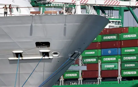 Evergreen container ship loaded with shipping containers (R) at the Port of Los Angeles on September 26, 2025 in Los Angeles, California. 