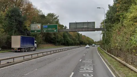 Google The A45 dual carriageway is shown, with a sign above both sides of the road showing the lanes for routes. 