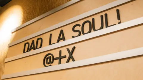 A wooden signs reads Dad La Soul
