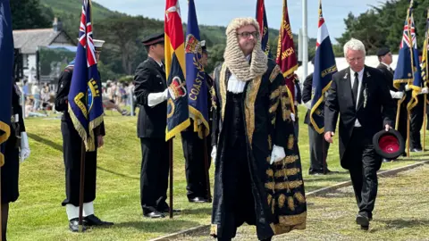 Watterson in the Speaker's black and gold robes and white wig at Tynwald Day.