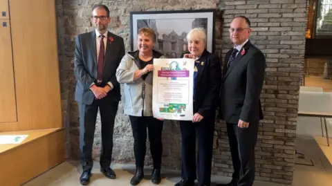 BBC Council leaders hold the agreement up.