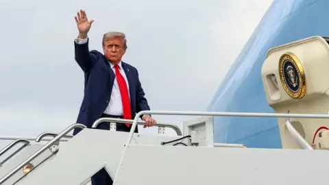 Reuters Donald Trump's waves in blue suit