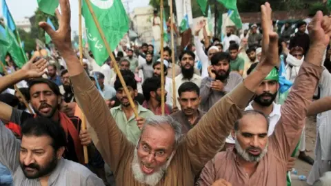 Pakistani men in Lahore chant slogans at a rally expressing solidarity with the people of Kashmir.