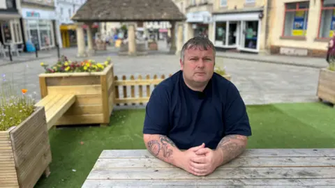 Liam Lathbury sitting at a table in Chippenham