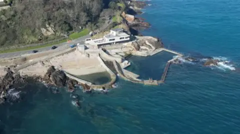 BBC An aerial view of La Vallette bathing pools in Guernsey on a sunny day