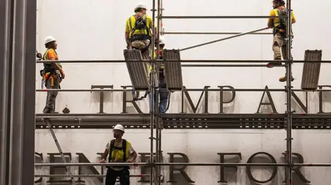 Workers put up scaffolding prior to the removal of President Donald Trump's name from the Kennedy Center on June 12, 2026 in Washington, DC.