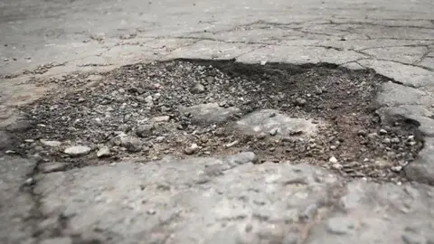 A close-up image of a pothole.