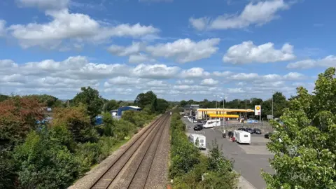 The railway line going through Cullompton and the car park that will be turned into Cullompton railway station