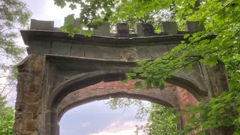 Martin Heath/BBC Close up of stone arch gate