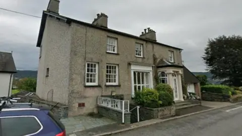 Google Wraysdale House. It is a pebble-dashed residential-looking building with steps leading down to the GP surgery.