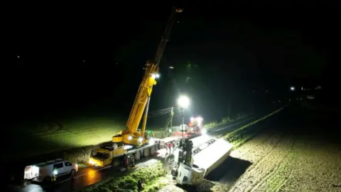 Crane in a field in the dark