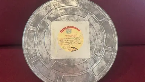 A circular film reel tin with a vintage BBC TV Enterprises label. It says 'Telerecording cutting copy' and has handwritten details on the label.