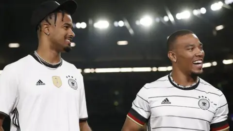 Equanimeous St Brown with his brother Amon-Ra St Brown at an international football friendly between Germany and Colombia in Gelsenkirchen in June 2023