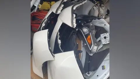 West Midlands Police Car parts stripped from a white vehicle, include bumpers
