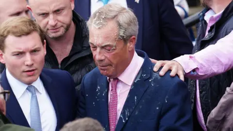 Getty Images Nigel Farage with a drink spilt over his head and suit jacket