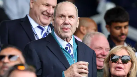 Michael Eisner looks on at Fratton Park