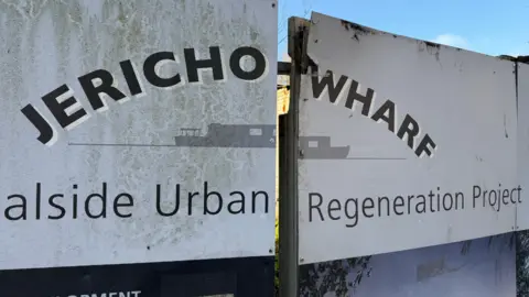 A sign for Jericho Wharf at the front of the site.