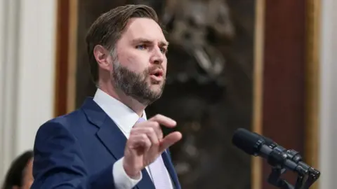 JD Vance speaking into a microphone. 