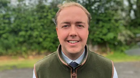 Man wearing a green gilet
