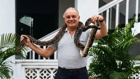 Sen Family Archive/Author’s Collection KC Sen handles a python 