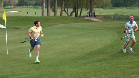 Two men running with golf clubs