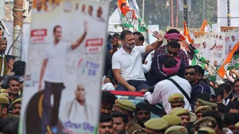 Getty Images India's Congress party leader Rahul Gandhi waves to supporters from atop a vehicle during the 'Bharat Jodo Yatra' roadshow in Varanasi on February 17, 2024. (Photo by Niharika KULKARNI / AFP) (Photo by NIHARIKA KULKARNI/AFP via Getty Images)