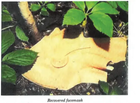 FBI and acting US Attorney General of Minnesota Facemask on ground with leaves surrounding