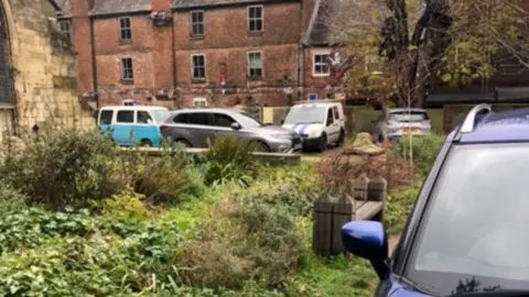 Local Democracy Reporting Service Cars parked next to the church