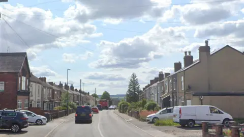 A Google Streetview of Williamthorpe Road shows terraced houses along the length of each side of the road. Traffic is queuing.