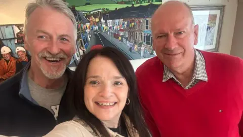 Buffy Williams/Bluesky A selfie-style photograph of Buffy Williams in the middle. She has Huw Irranca-Davies to the left and David Rees to the right.