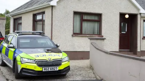 Police car outside house