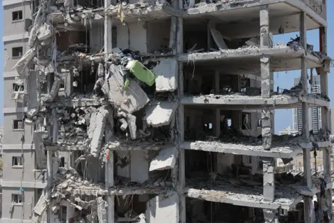 A partially collapsed residential building after Iranian ballistic missiles hit Bat Yam, central Israel