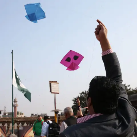 Getty Images LAHORE, PAKISTAN - FEBRUARY 6: People attend the kite flying evet, which had been banned nationwide following past deaths and serious injuries during festivals, is permitted again in the historic Delhi Gate area on February 6, in Lahore, Pakistan. (Photo by Muhammed Semih Ugurlu/Anadolu via Getty Images)