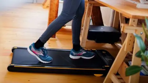 Getty Images File photo: someone in blue and pink trainers using a walk pad