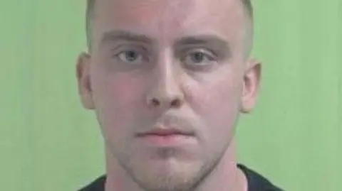 IOM Constabulry A police mugshot of Billy Marina, who has close-cropped brown hair and stubble.