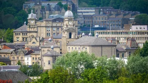 Getty Images The Dewsbury skyline. Featured are several old mill buildings and the town clock.