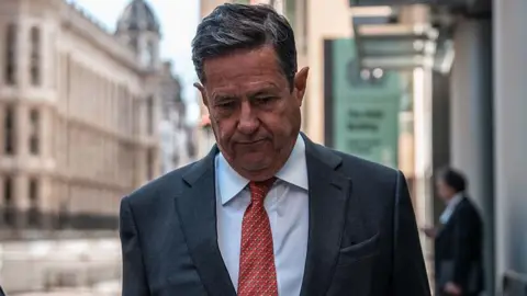 Getty Images Former Barclays boss Jes Staley wearing a suit with red dotted tie, walking outside