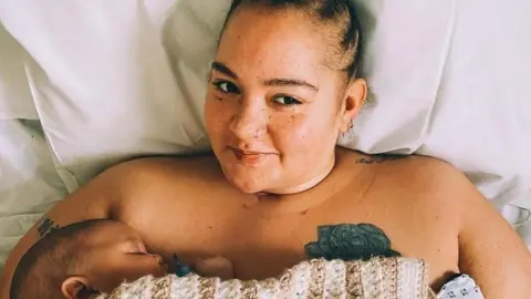 Grace Victory Grace in a hospital bed holding her baby