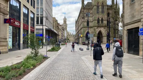 The view down a main, pedestrianised street in Bradford city centre.