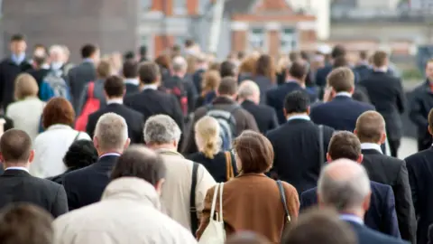 Getty Images Group of people walking from behind during a busy rush hour in London