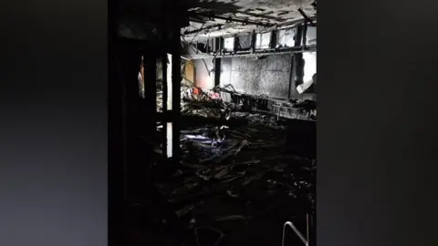 Stockton Borough Council A blackened room full of debris and furniture.